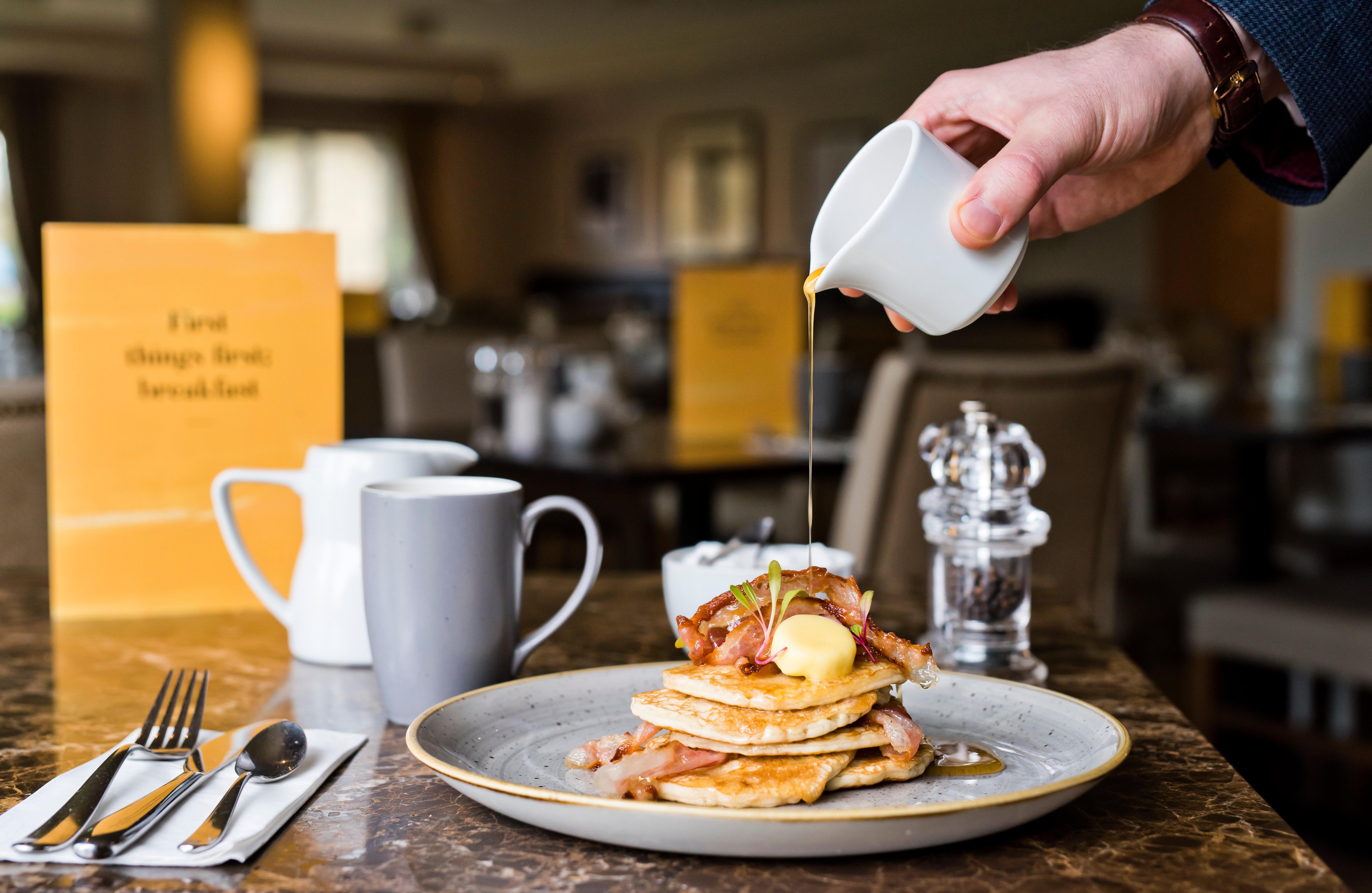 Voco Orchard Singapore By Ihg מראה חיצוני תמונה Maple syrup being poured over a stack of pancakes